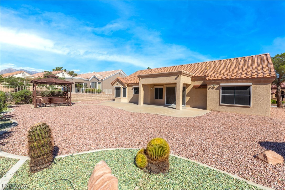 9433 Quail Ridge Drive Las Vegas, NV 89134 - Photo 7 of 25 This desert retreat boasts a spacious patio and a charming gazebo, perfect for outdoor enjoyment.