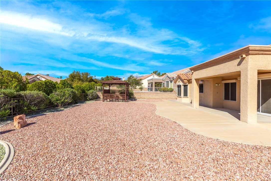 9433 Quail Ridge Drive Las Vegas, NV 89134 - Photo 8 of 25 This spacious yard features a gazebo, ample patio space, and low-maintenance landscaping.