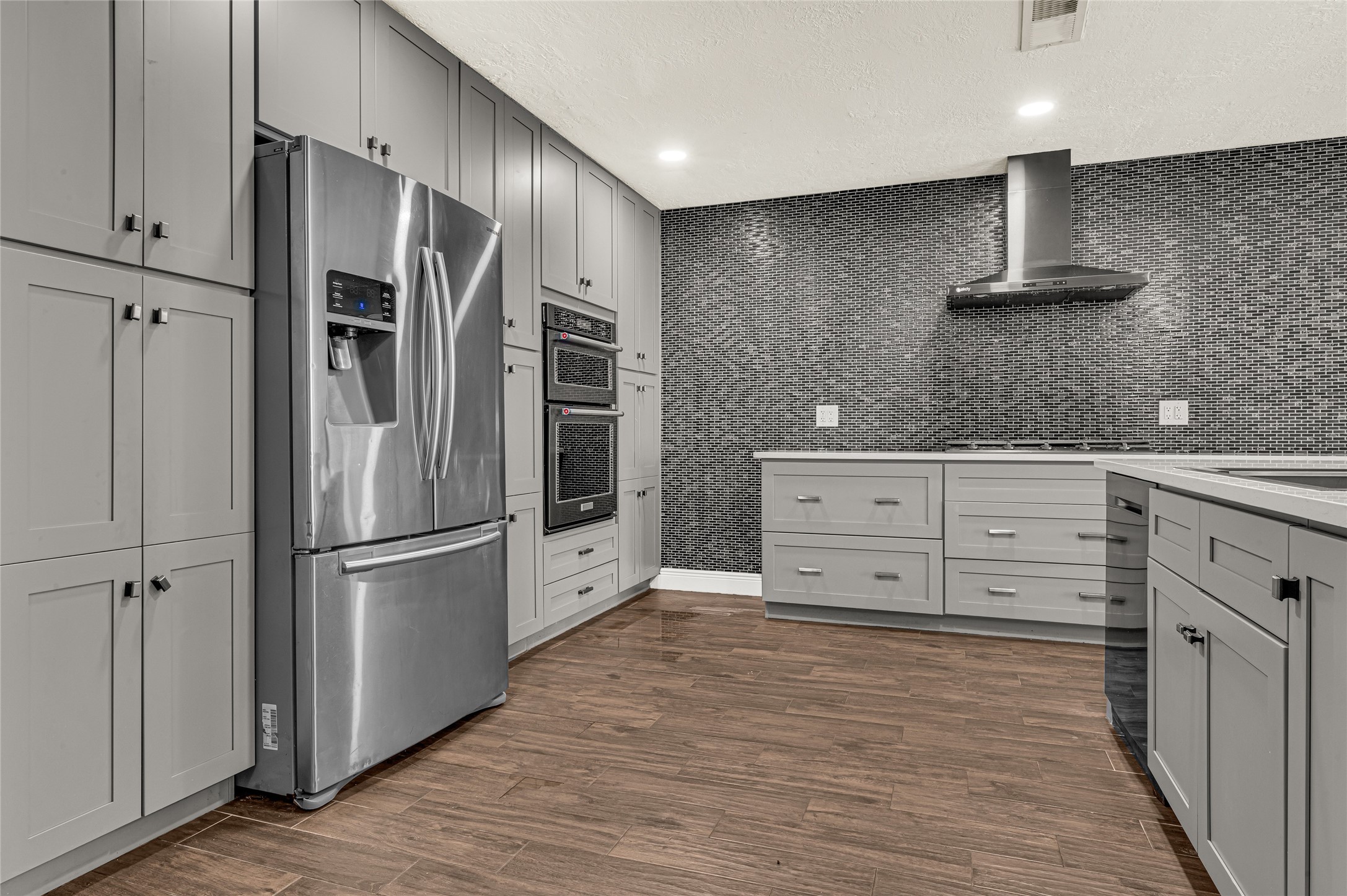 4170 Amir Street Houston, TX 77072 - Photo 7 of 18 a kitchen with stainless steel appliances a refrigerator and cabinets