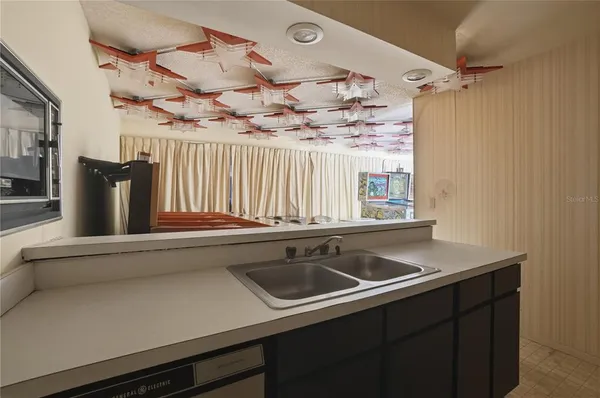 a bedroom with a bed and a tv on the dresser