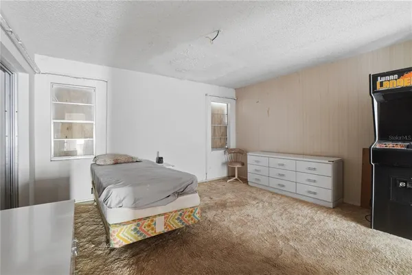 a bedroom with a bed and a television