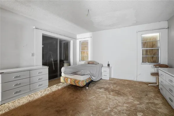 a bathroom with a granite countertop sink a toilet and a mirror