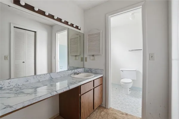 a white toilet sitting next to a bath tub