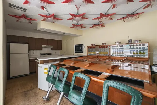 a kitchen with stainless steel appliances a refrigerator a stove a microwave and sink