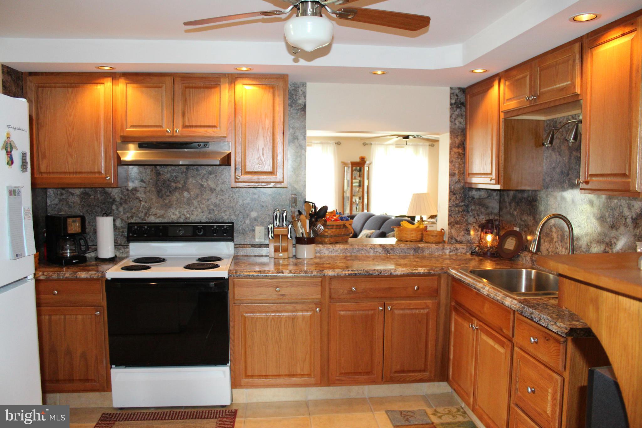 11191 Big Pool Road Big Pool, MD 21711 - Photo 11 of 30 a kitchen with stainless steel appliances granite countertop a stove a sink and a microwave