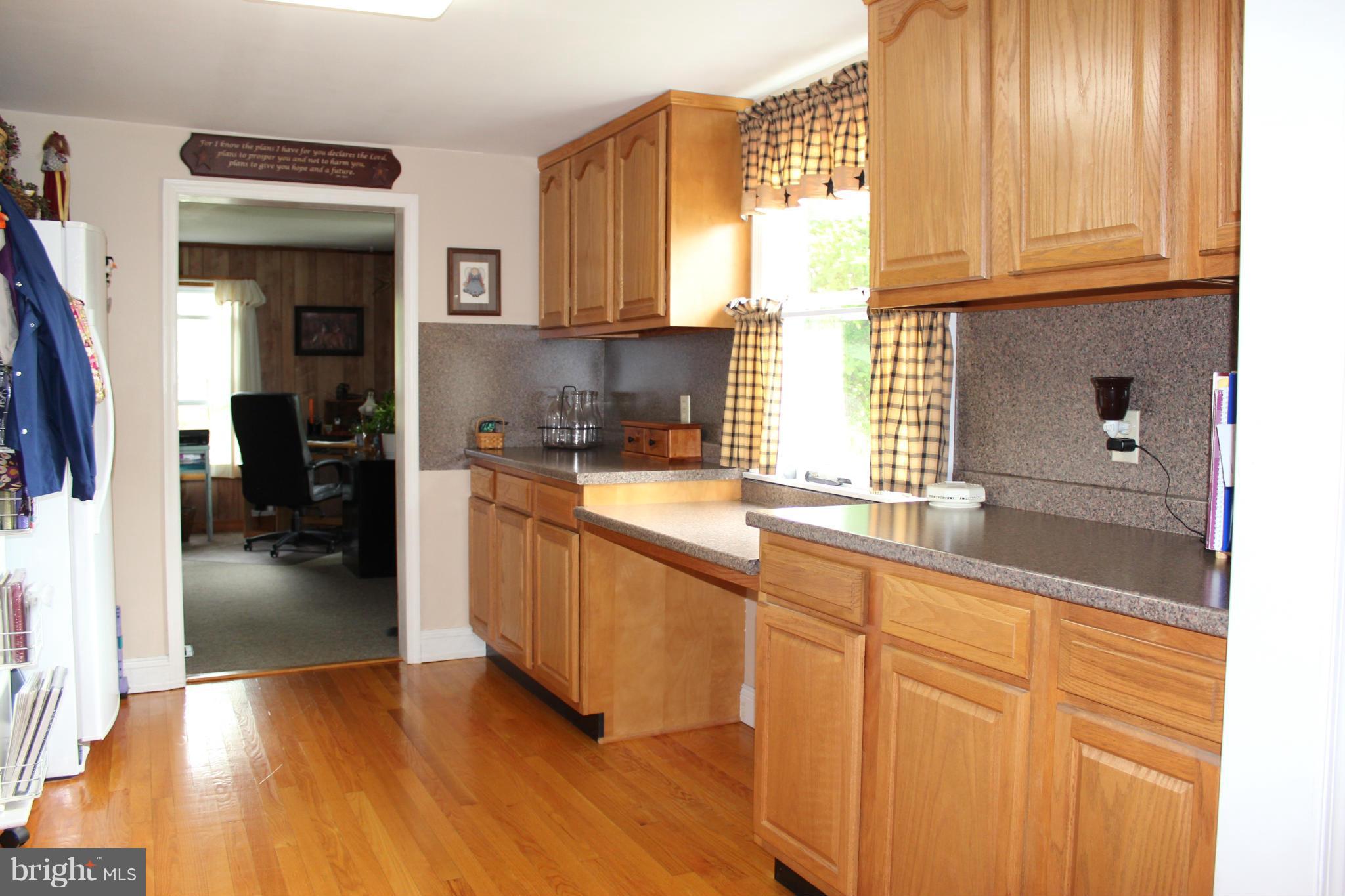 11191 Big Pool Road Big Pool, MD 21711 - Photo 12 of 30 a kitchen with stainless steel appliances granite countertop a sink and cabinets