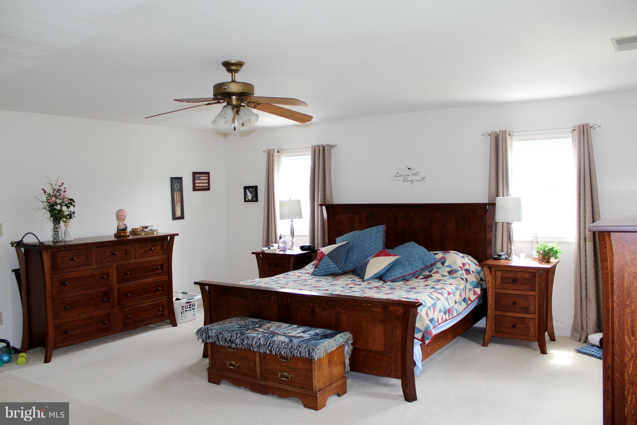 11191 Big Pool Road Big Pool, MD 21711 - Photo 18 of 30 a bedroom with a bed and a chandelier