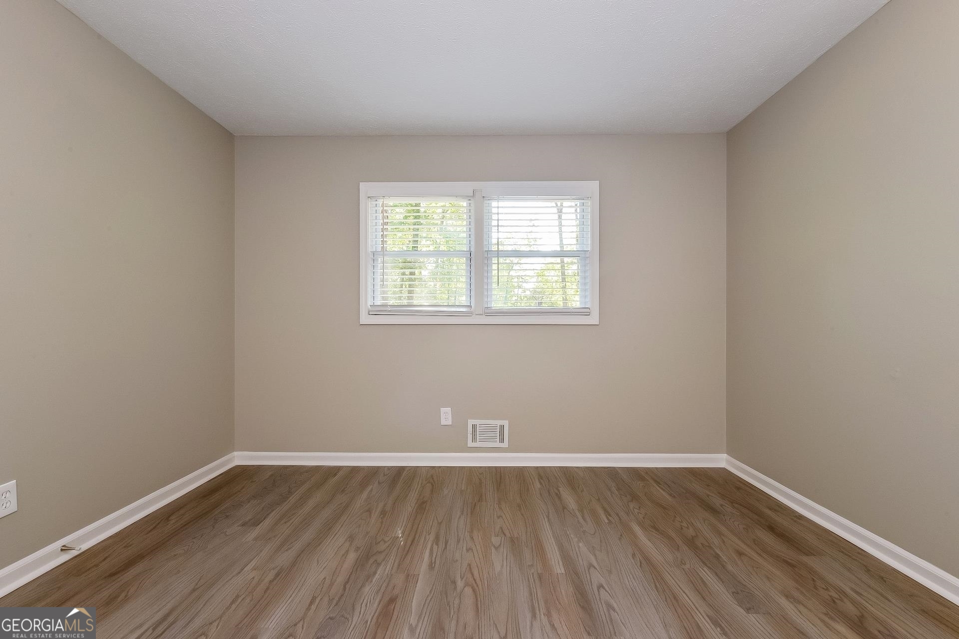 109 Landover Drive Stockbridge, GA 30281 - Photo 11 of 16 an empty room with wooden floor and windows