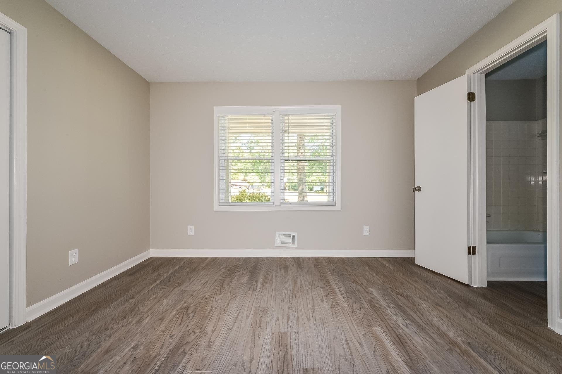 109 Landover Drive Stockbridge, GA 30281 - Photo 12 of 16 an empty room with wooden floor and windows