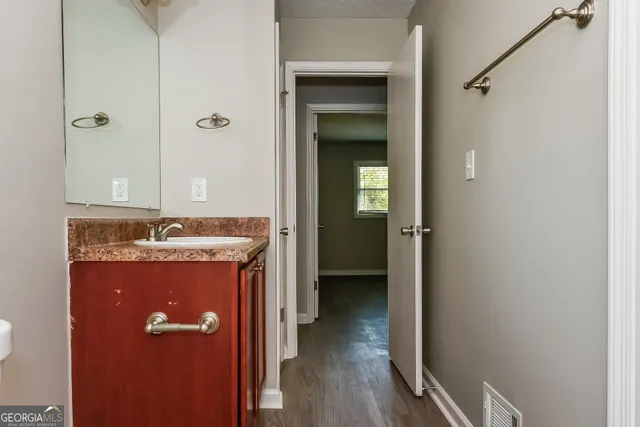 a view of a hallway with wooden floor