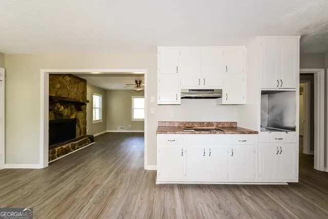 a kitchen with granite countertop a stove and a refrigerator