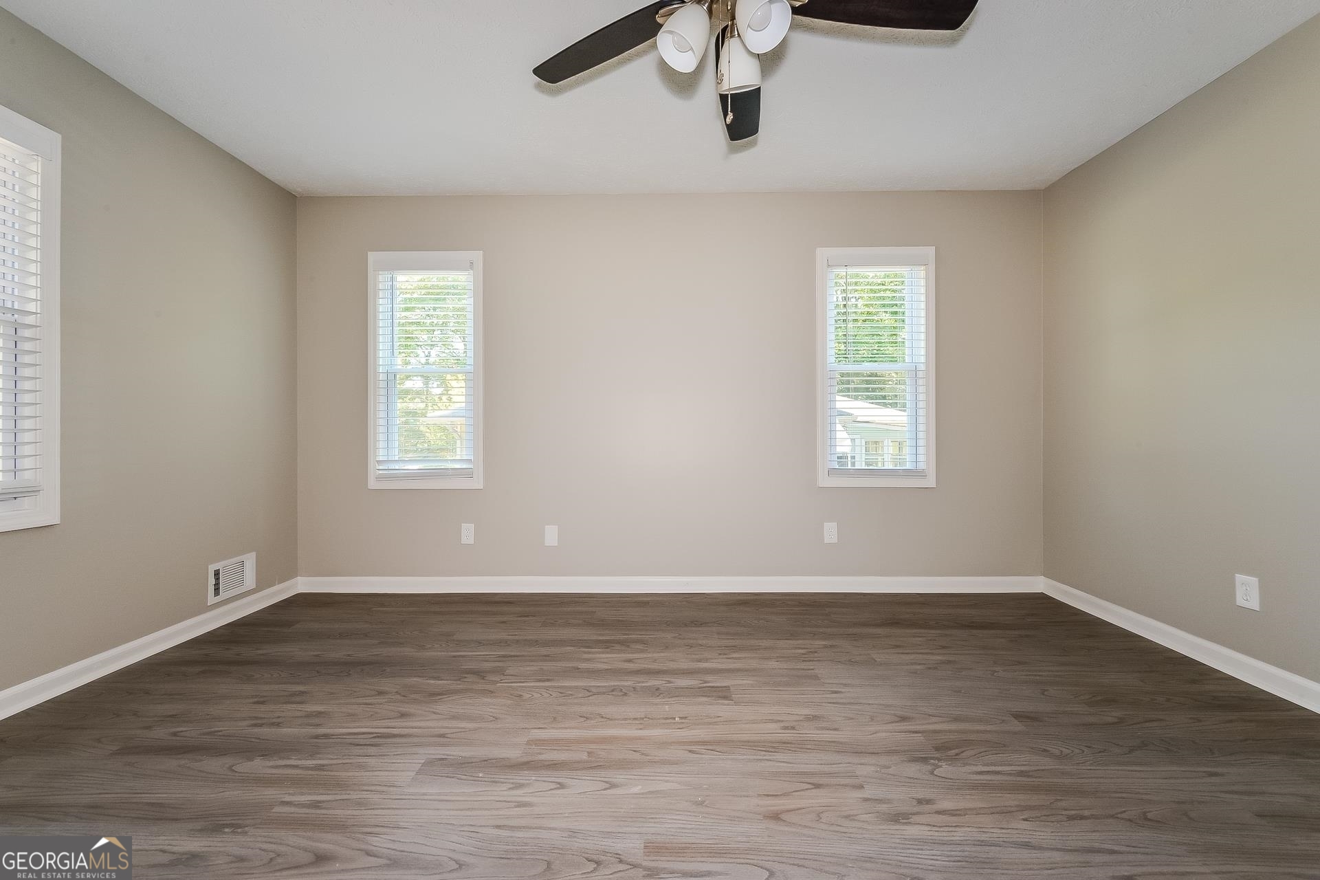 109 Landover Drive Stockbridge, GA 30281 - Photo 9 of 16 a view of an empty room with wooden floor and a window