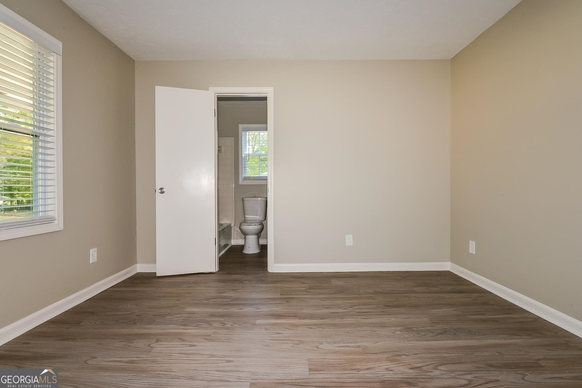 109 Landover Drive Stockbridge, GA 30281 - Photo 10 of 16 a view of an empty room with wooden floor and a window