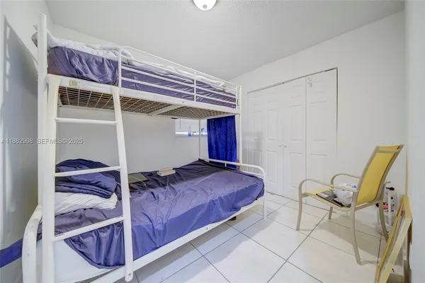 a kitchen with a sink a stove and storage racks