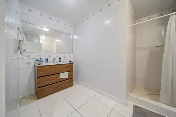 a kitchen with kitchen island granite countertop a sink cabinets and window