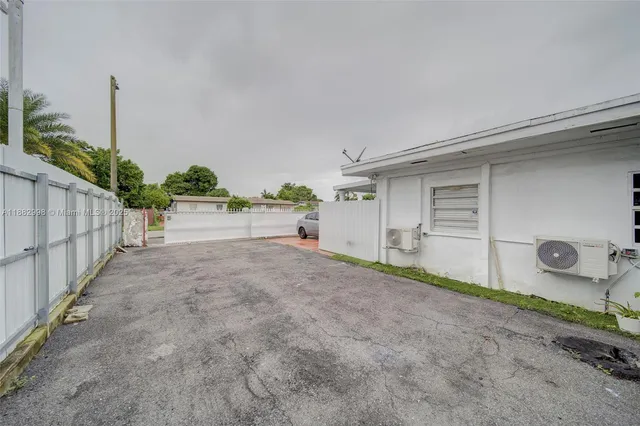 a kitchen with a refrigerator and white cabinets