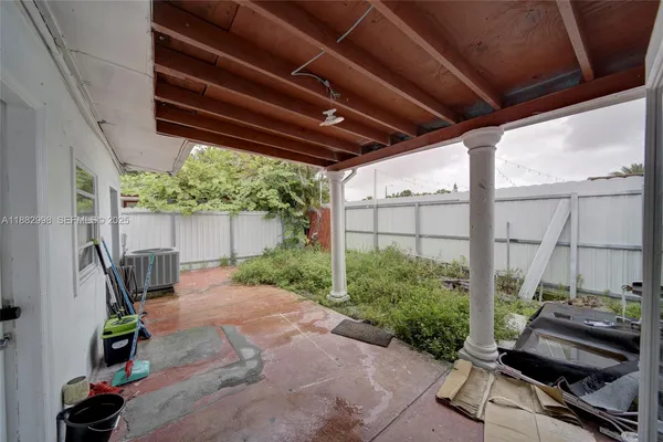 a view of a backyard with furniture and a garage