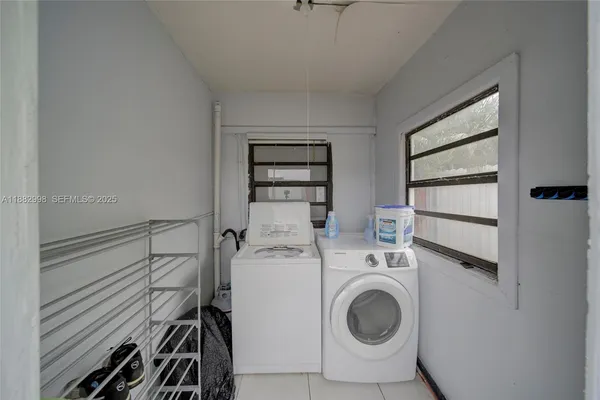 a room with furniture a rug and a flat screen tv