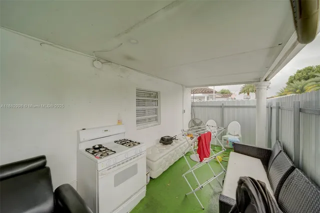 a view of a livingroom with furniture and kitchen view