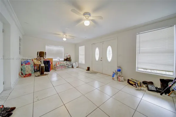 a kitchen with a sink a stove a kitchen island with chairs and wooden floor