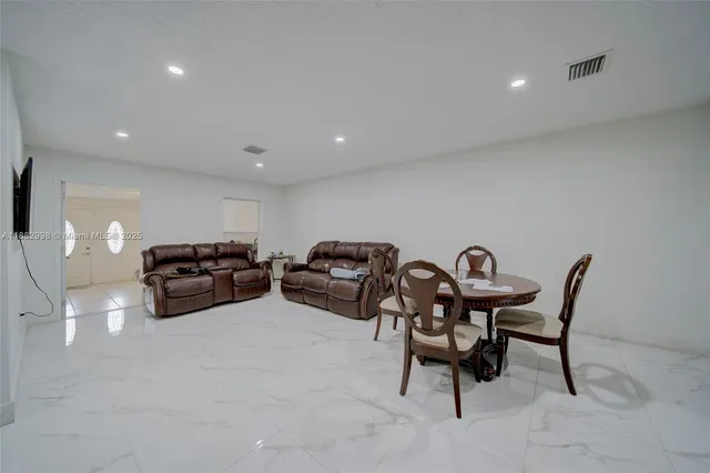 a kitchen with stainless steel appliances a stove a sink a microwave a refrigerator and cabinets