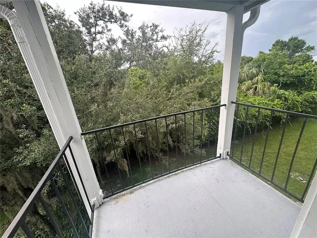 a balcony with trees in front of it