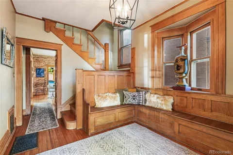 a living room with furniture a fireplace and a potted plant