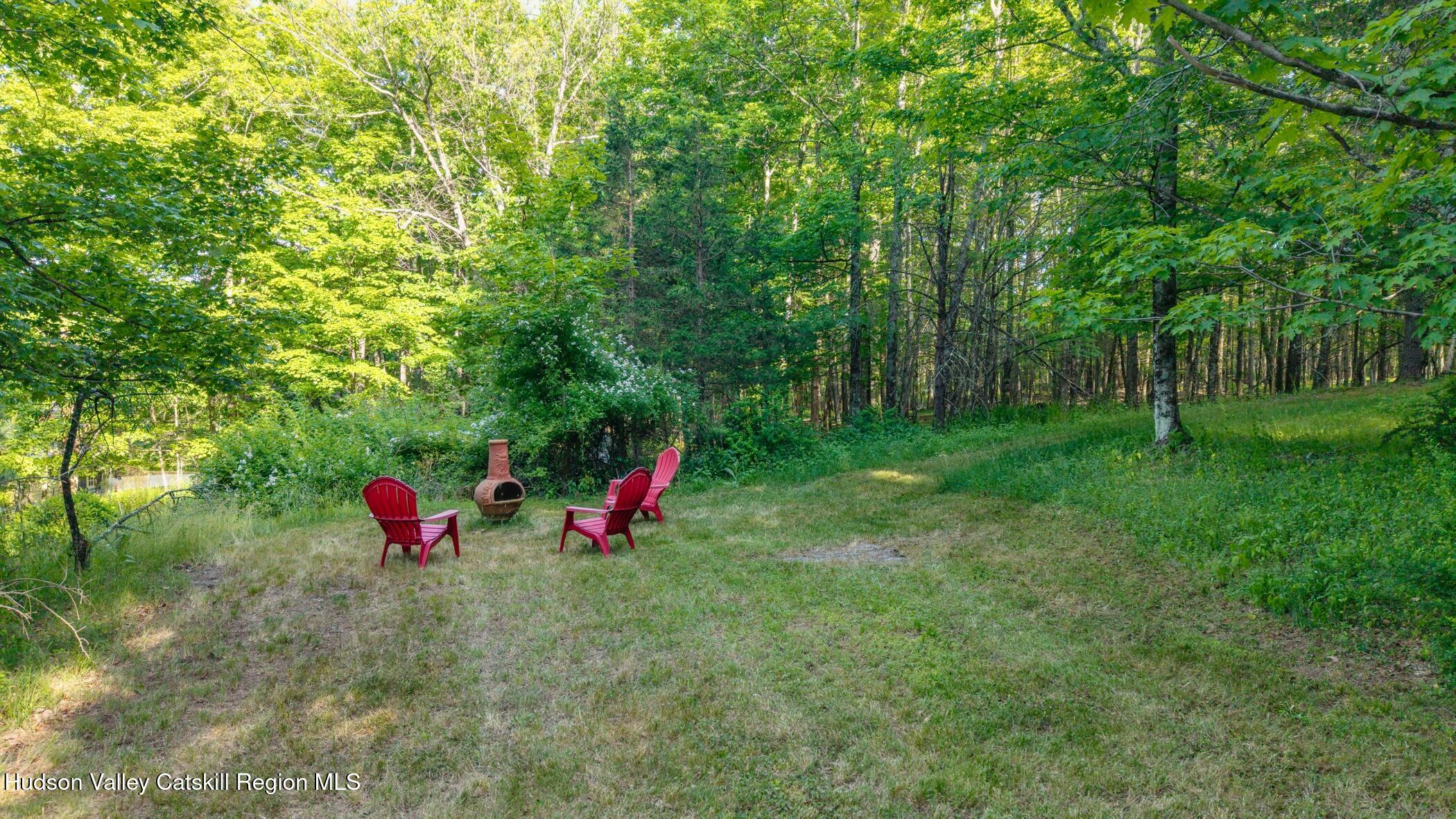 4533 Atwood Road Stone Ridge, NY 12484 - Photo 56 of 63 a view of a fire pit with large trees