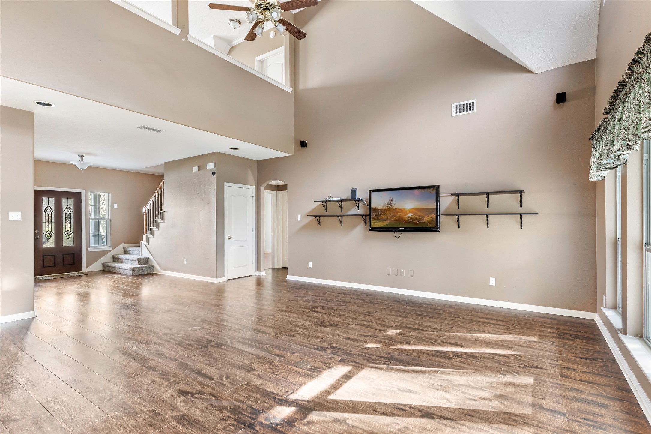 123 Burwell Road Highlands, TX 77562 - Photo 13 of 32 a view of a livingroom with wooden floor and a ceiling fan