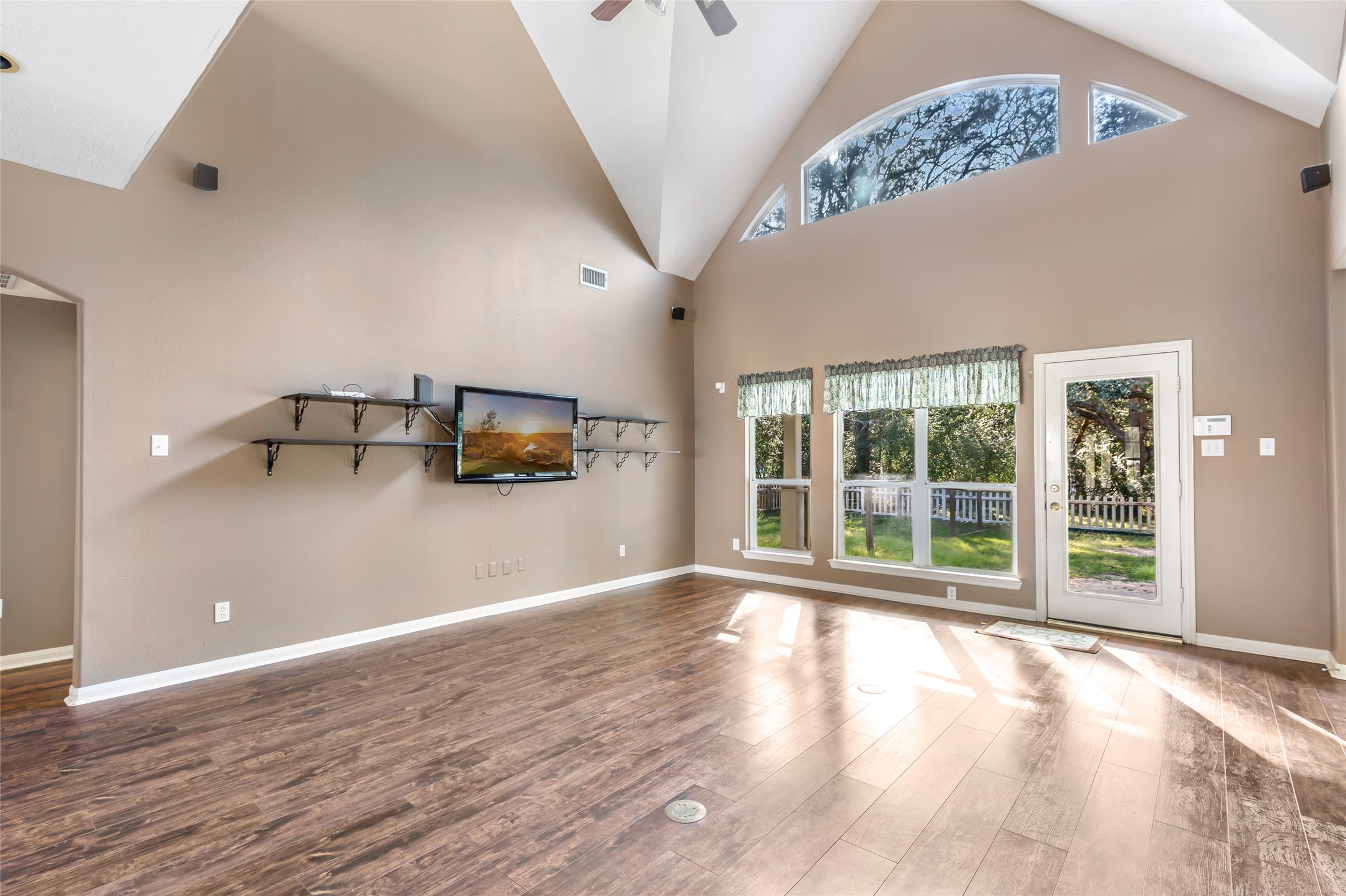 123 Burwell Road Highlands, TX 77562 - Photo 14 of 32 a view of empty room with wooden floor and fan