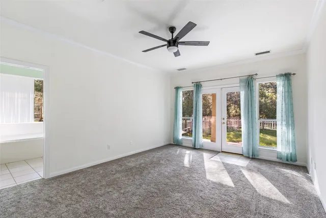 a view of a livingroom with a ceiling fan and window