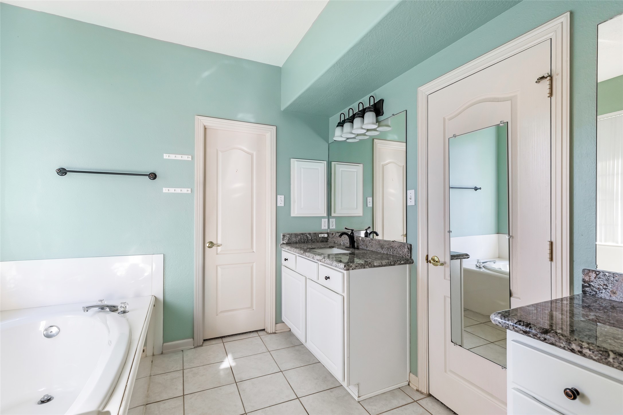 123 Burwell Road Highlands, TX 77562 - Photo 16 of 32 a bathroom with a granite countertop sink a toilet and a mirror