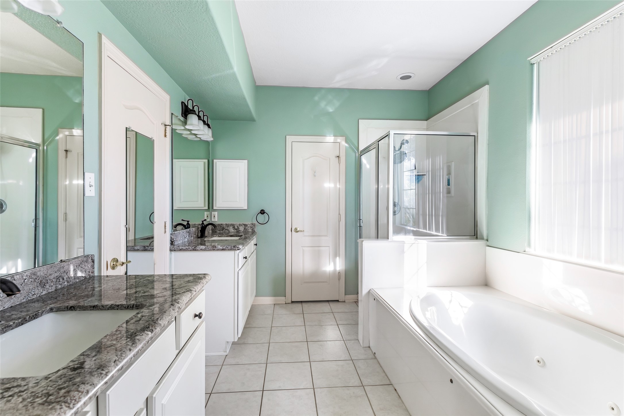 123 Burwell Road Highlands, TX 77562 - Photo 17 of 32 a large bathroom with a granite countertop tub sink and mirror