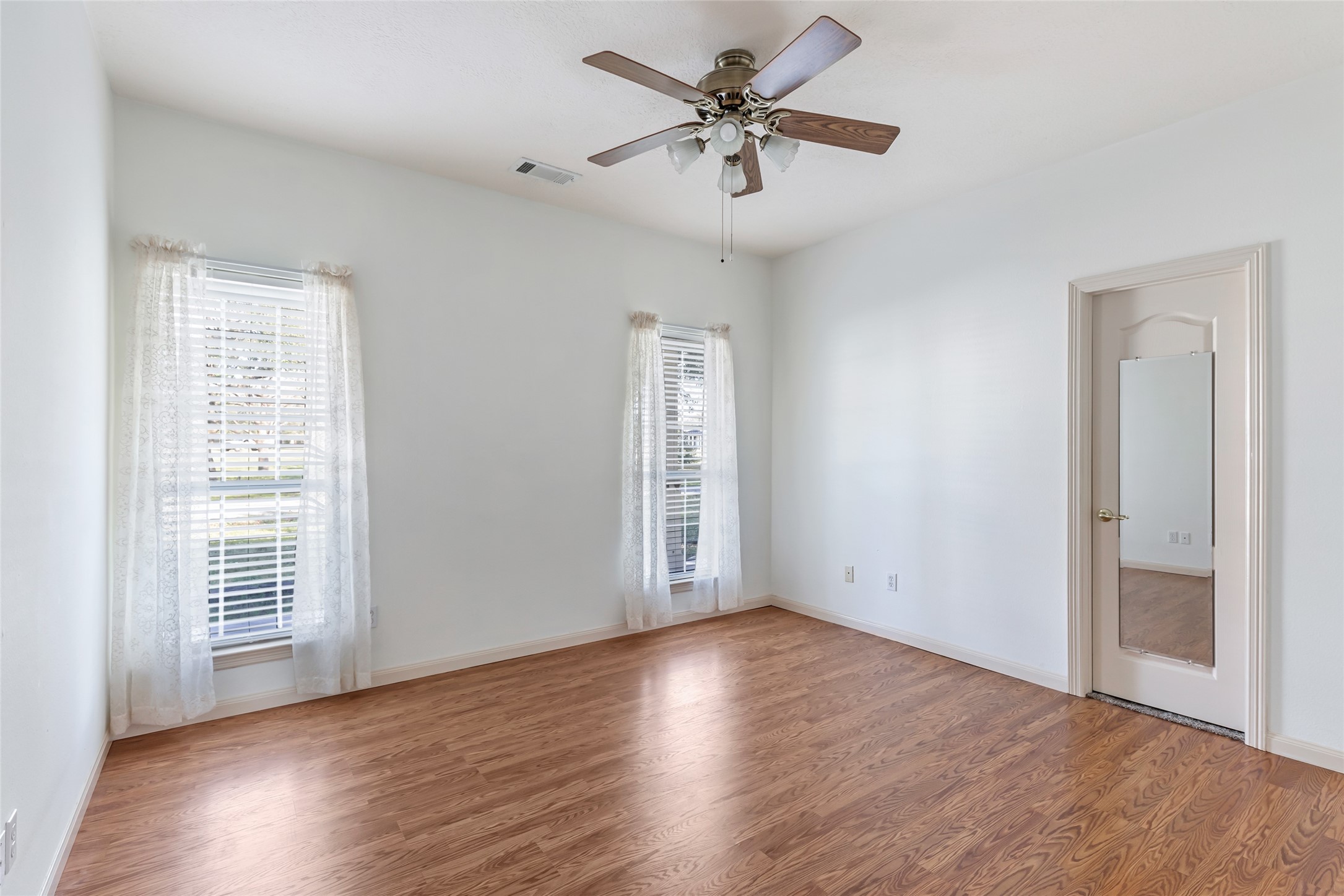 123 Burwell Road Highlands, TX 77562 - Photo 19 of 32 an empty room with wooden floor and windows