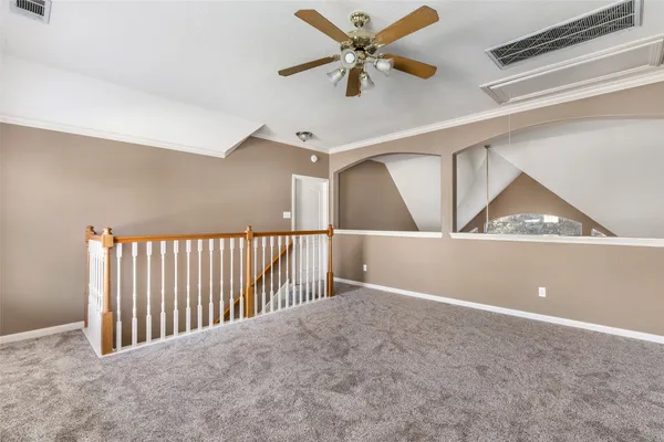 a view of a hallway with a ceiling fan