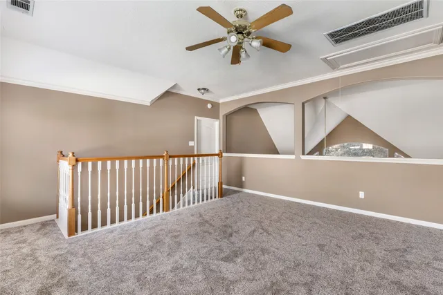 a view of a hallway with a ceiling fan