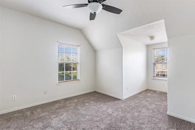 a bathroom with a granite countertop sink a toilet and a shower