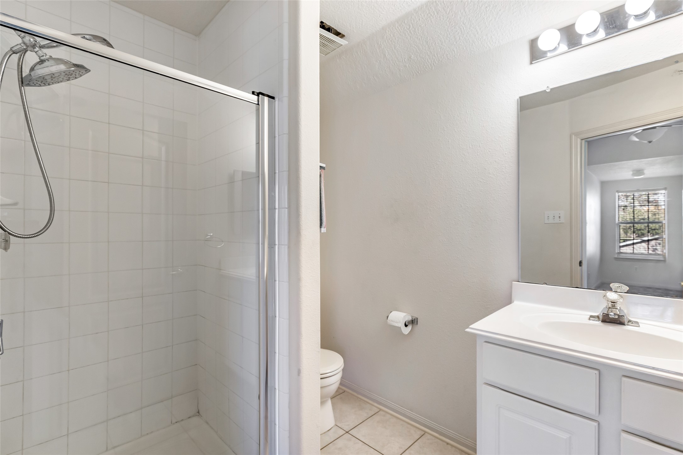 123 Burwell Road Highlands, TX 77562 - Photo 25 of 32 a bathroom with a granite countertop sink a toilet and a shower