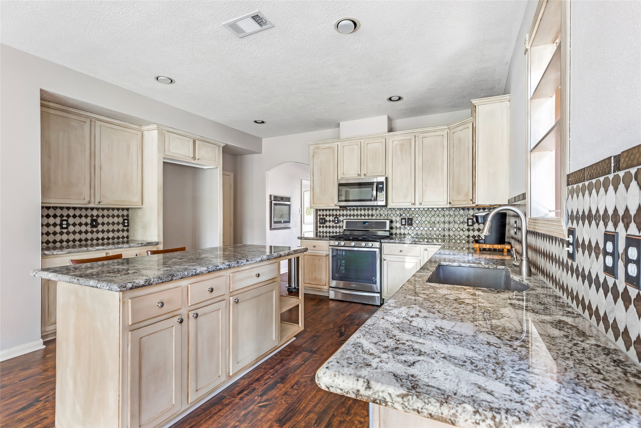 123 Burwell Road Highlands, TX 77562 - Photo 8 of 32 a kitchen with stove top oven and refrigerator