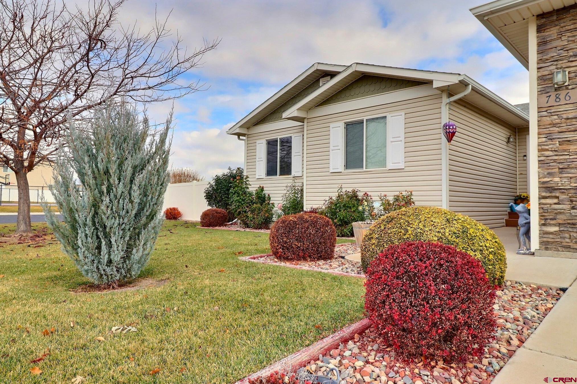 786 Dutton Street Delta, CO 81416 - Photo 2 of 29 Beautiful landscaping yet easy to maintain blending lawn, trees, shrubs, flowers, xeroscaping and even artificial grass