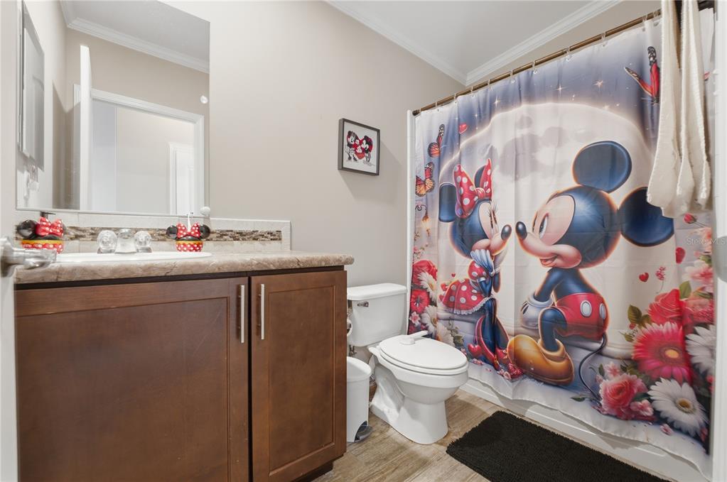 6844 Chad Jason Road St. Cloud, FL 34773 - Photo 39 of 59 a bathroom with a sink mirror vanity and toilet