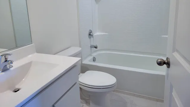 a bathroom with a sink a toilet and bathtub