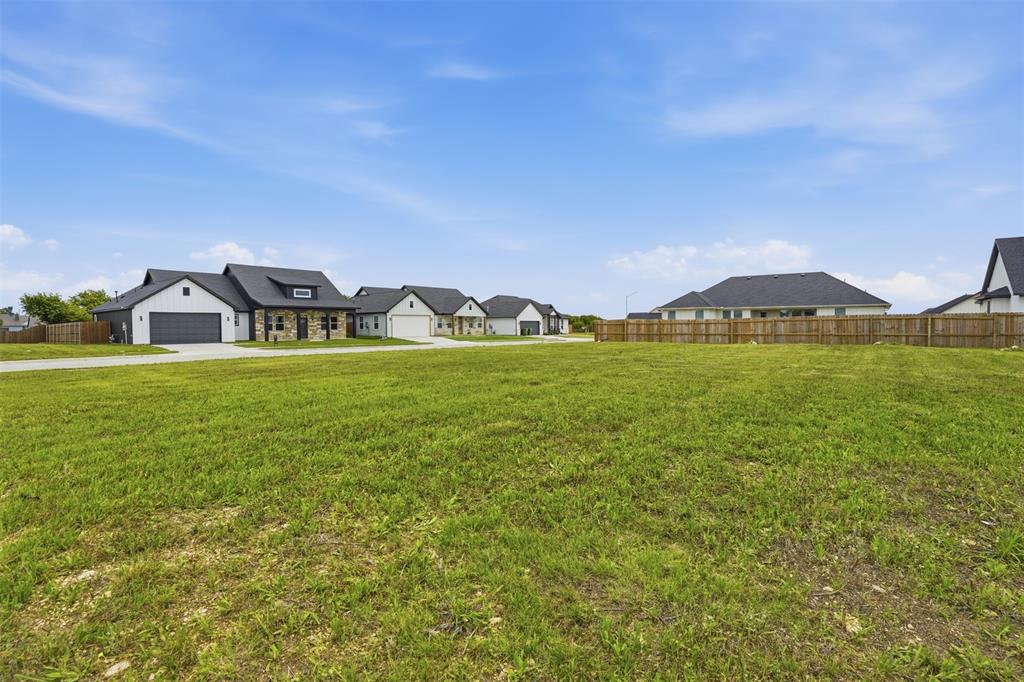585 Highview Court Godley, TX 76044 - Photo 3 of 15 a view of a house with a yard and a large tree