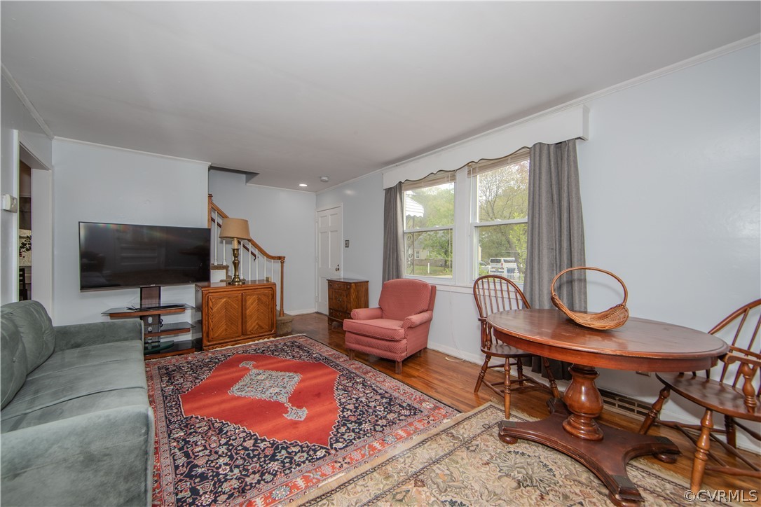6736 Strathmore Road Richmond, VA 23237 - Photo 12 of 25 a living room with furniture a flat screen tv and a window