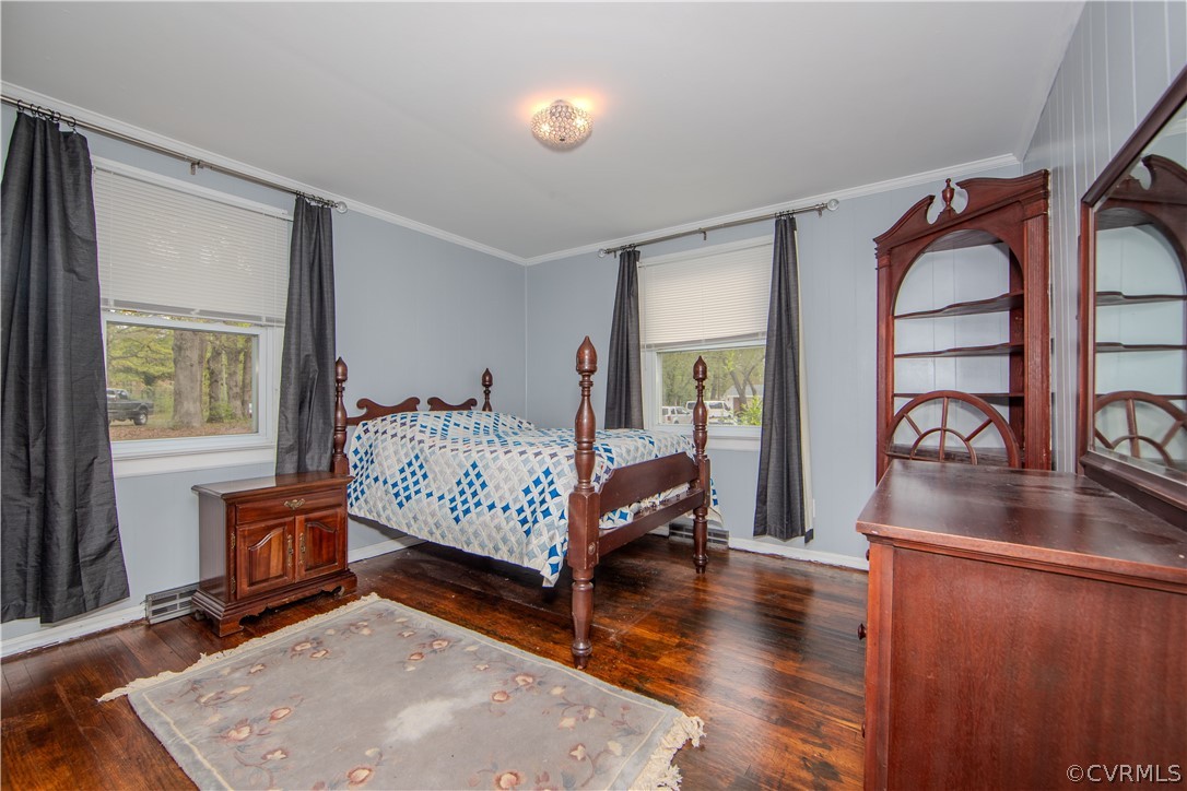 6736 Strathmore Road Richmond, VA 23237 - Photo 19 of 25 a bedroom with furniture and a wooden floor