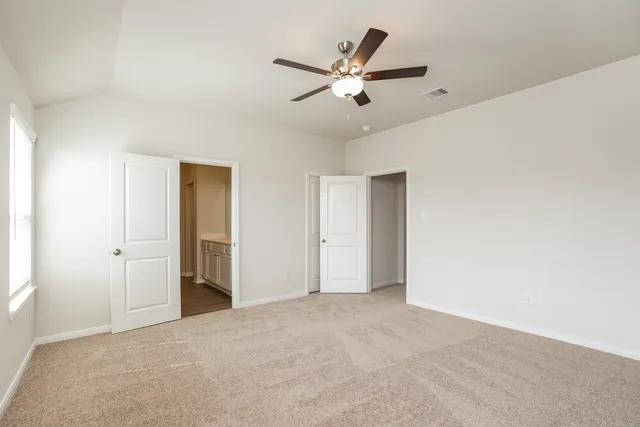 a view of an empty room with a ceiling fan