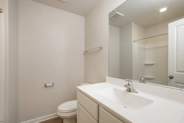 a bathroom with a sink toilet and a mirror