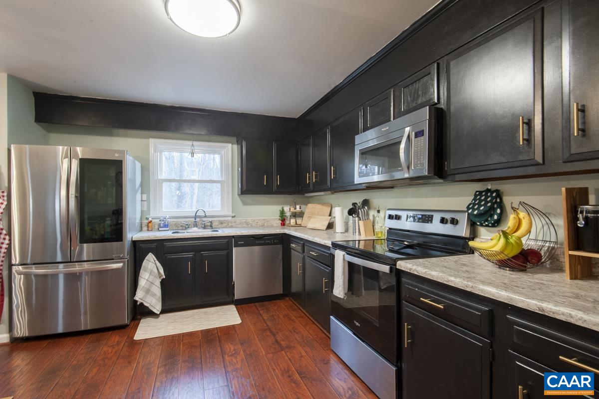 145 Georgetown Green Charlottesville, VA 22901 - Photo 11 of 43 a kitchen with granite countertop stainless steel appliances and wooden cabinets