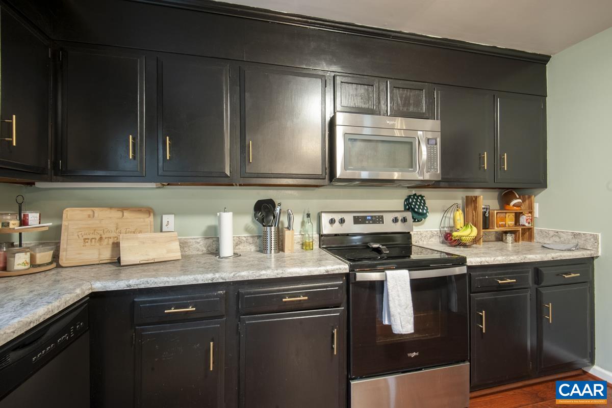 145 Georgetown Green Charlottesville, VA 22901 - Photo 12 of 43 a kitchen with granite countertop a sink a stove and cabinets