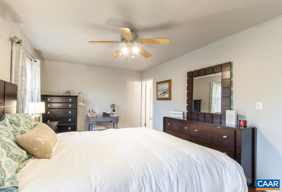 145 Georgetown Green Charlottesville, VA 22901 - Photo 13 of 43 a bedroom with a bed and a chandelier